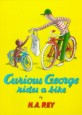(Curious George) rides a bike
